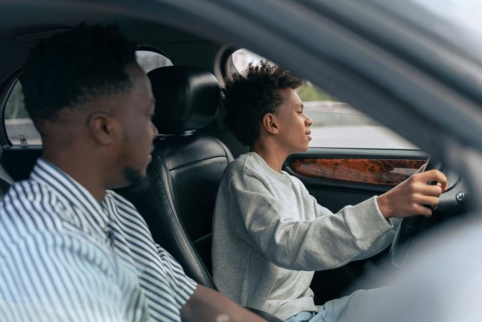 Man in White and Black Striped Dress Shirt Driving Car