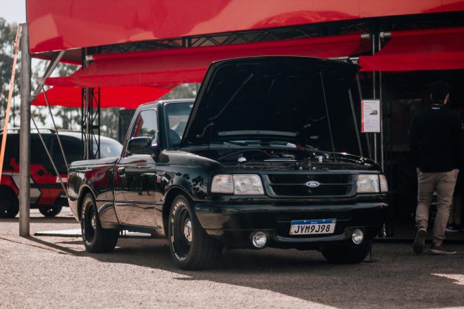 a black truck parked in front of a red awning