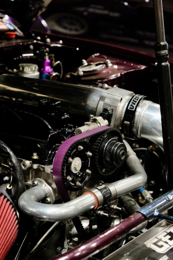 A close up of a car's engine and its intake